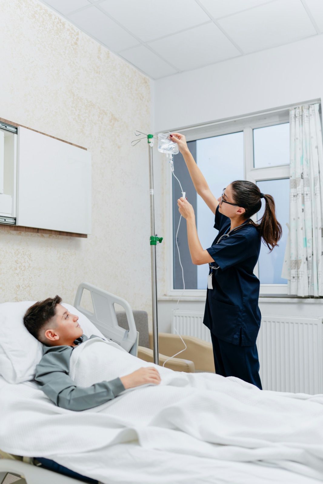 A nurse adjusting an IV line